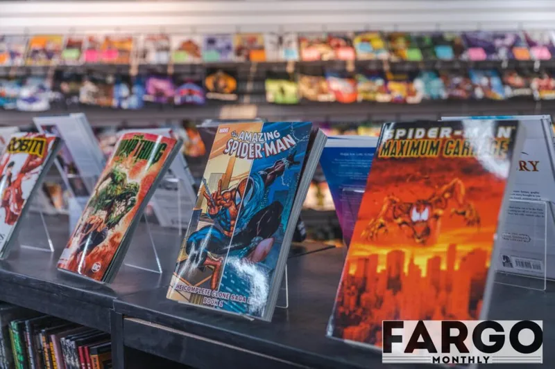 Comic book graphic novels on display including Amazing Spider-Man and Spider-Man Maximum Carnage