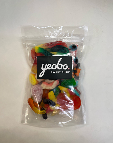 Clear bag of colorful mixed gummy candies labeled Yeabo Sweet Shop