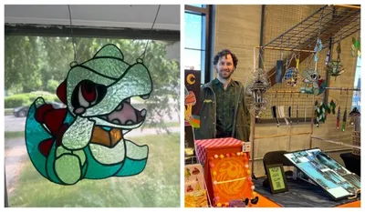 Stained glass cartoon snake suncatcher beside a man standing at a craft market booth displaying glass art