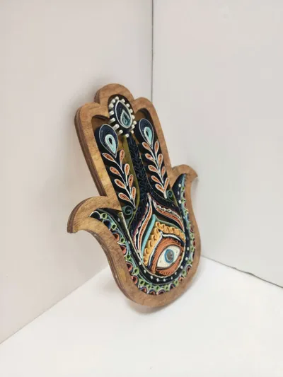 Wooden hamsa hand with colorful painted eye and floral motifs