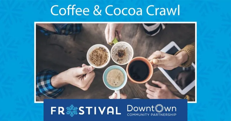 Four hands clinking mugs of coffee and cocoa over a wooden table, overhead view