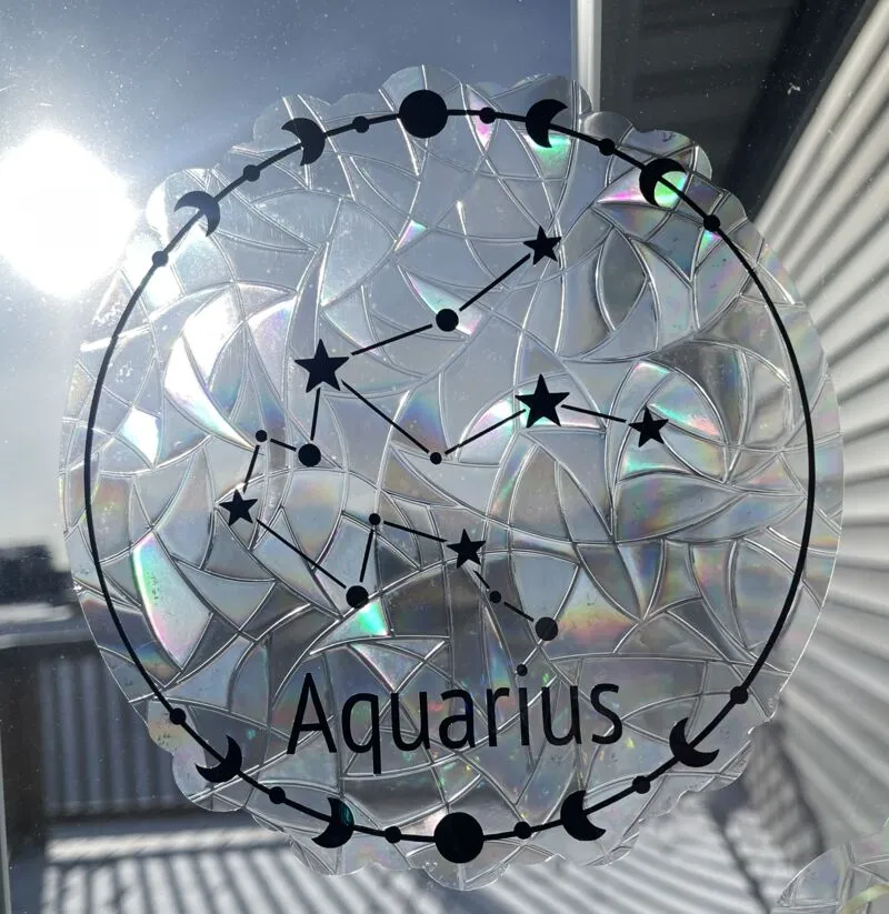 Round iridescent holographic suncatcher with Aquarius constellation and moon phase border