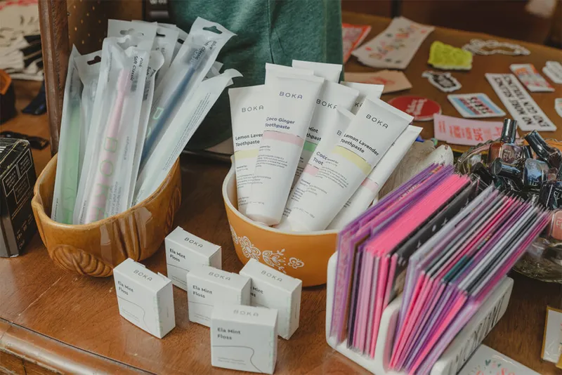 Boka toothpaste tubes and floss boxes in ceramic bowls on a store display table