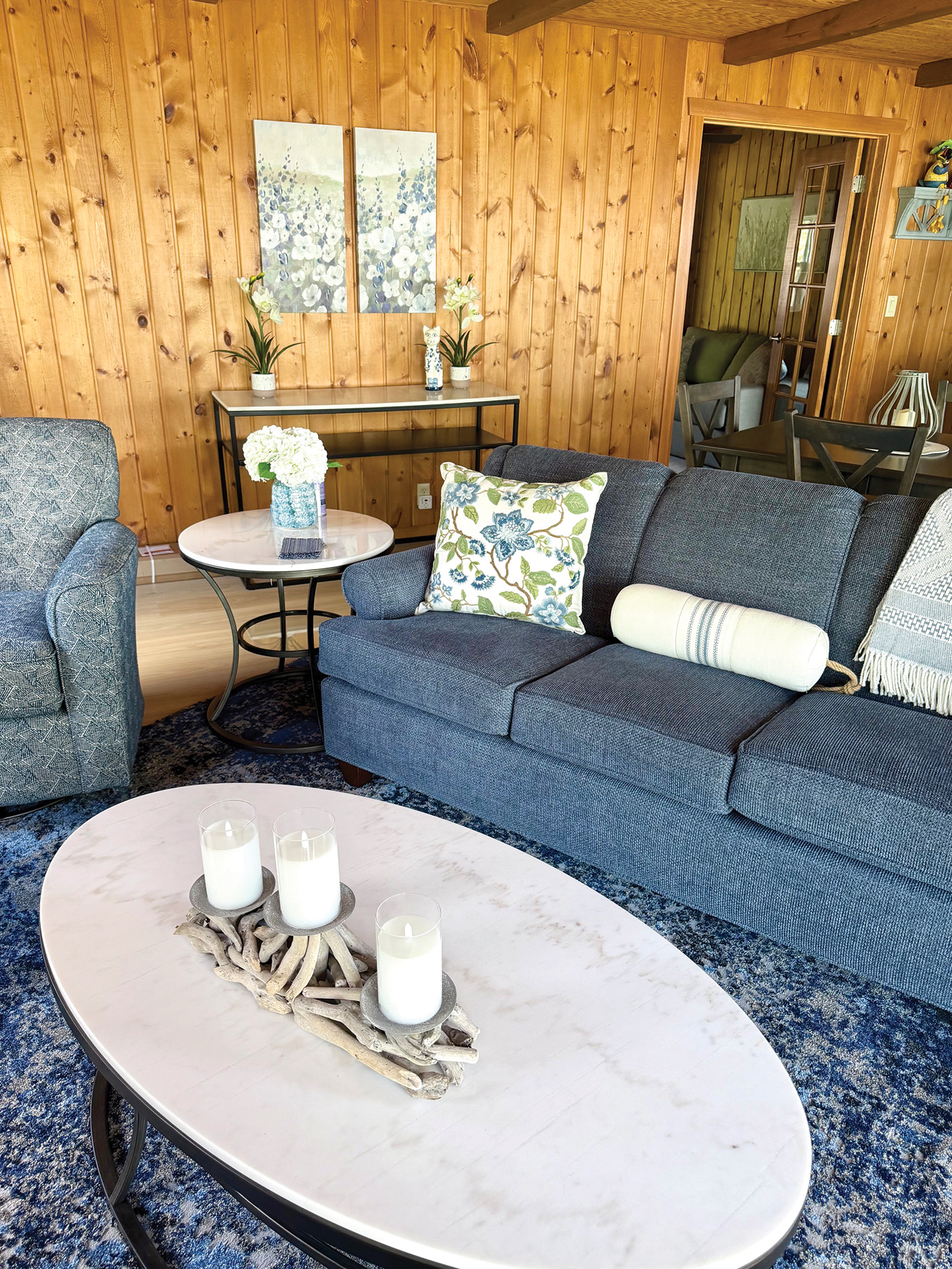 Lake cottage living room with a blue sofa and oval coffee table