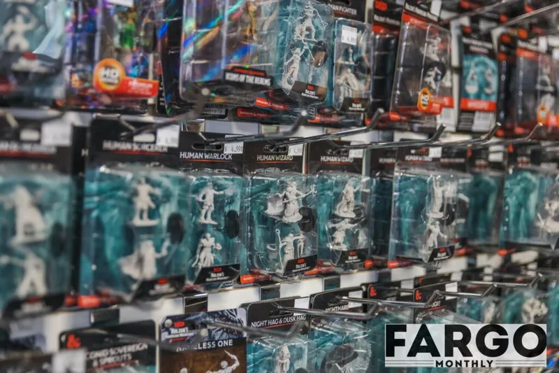 Store shelf packed with packaged tabletop RPG miniature figures