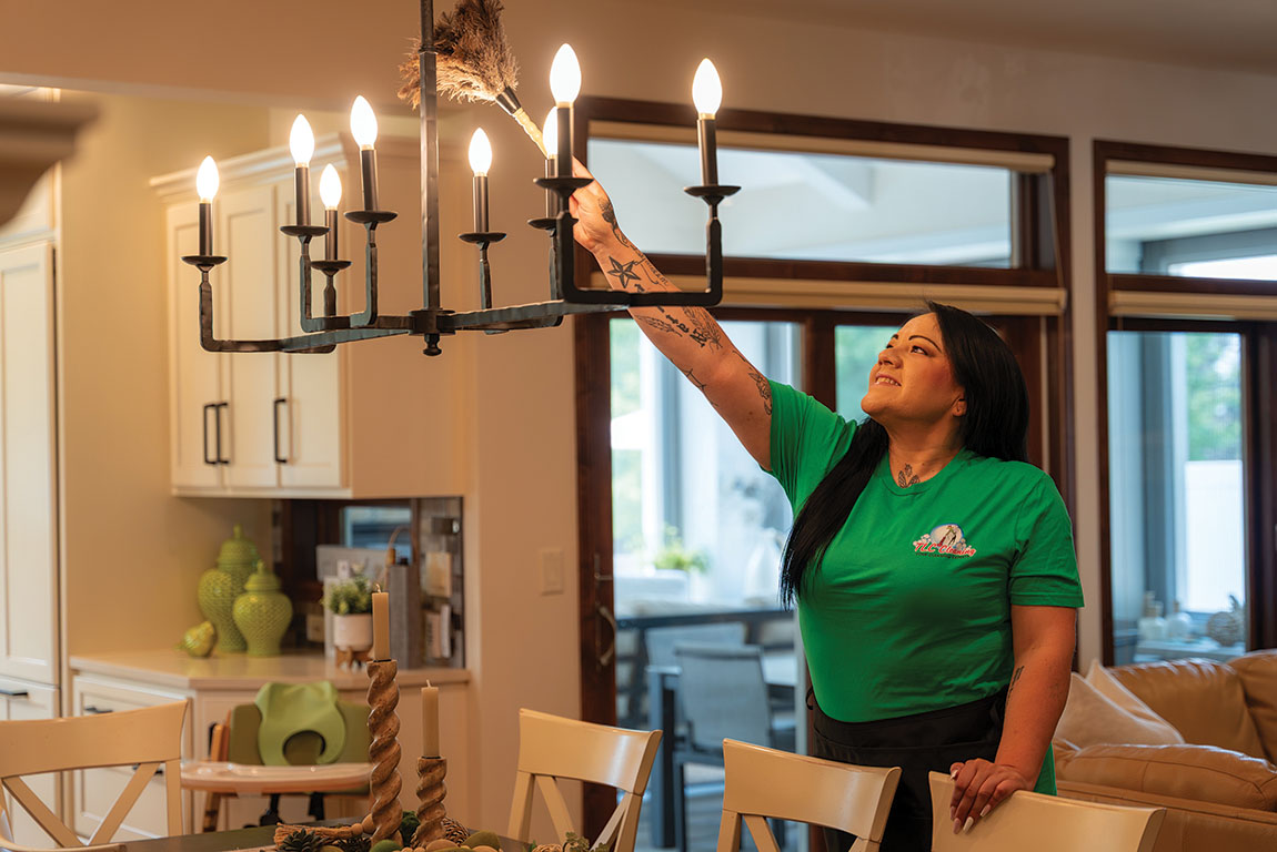 Veronica McCloud cleaning a chandelier