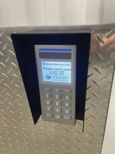 Noka Smart Entry keypad with numeric buttons mounted on diamond-plate metal panel