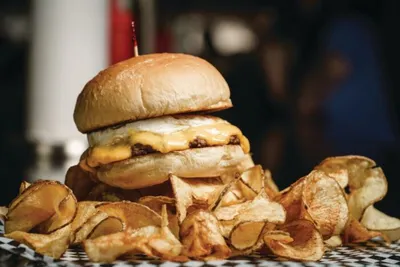 Double cheeseburger on a brioche bun served with thick-cut potato chips