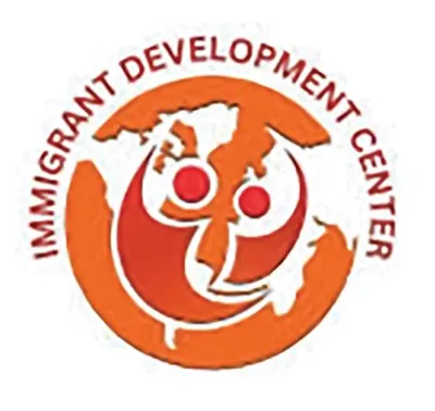 Circular orange logo for the Immigrant Development Center with a world map graphic
