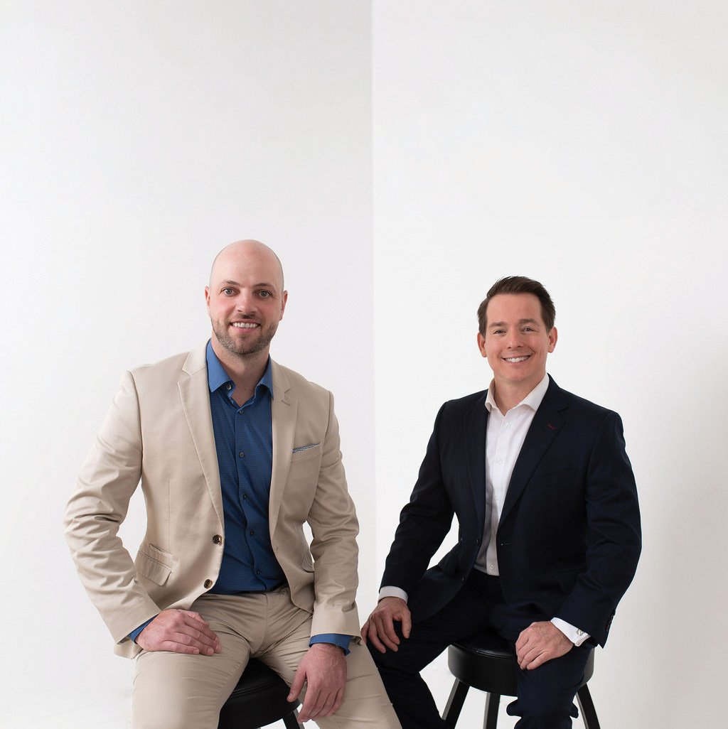 Dr. Ryan Smart and Dr. Corbett Haas seated side by side against a white backdrop