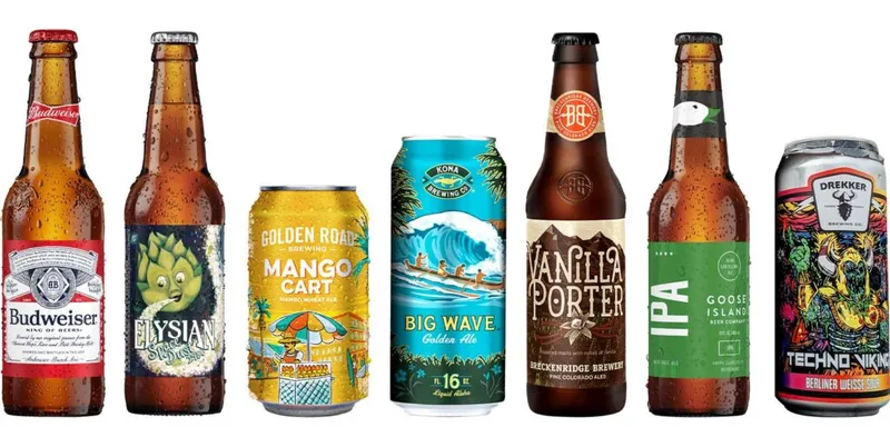 Seven beer bottles and cans lined up including Budweiser, Elysian, Mango Cart, Kona Big Wave, Vanilla Porter, Goose Island