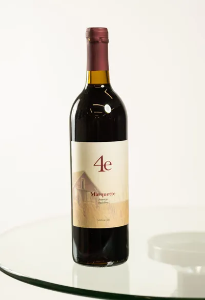 Bottle of 4e Marquette American red wine on a glass table