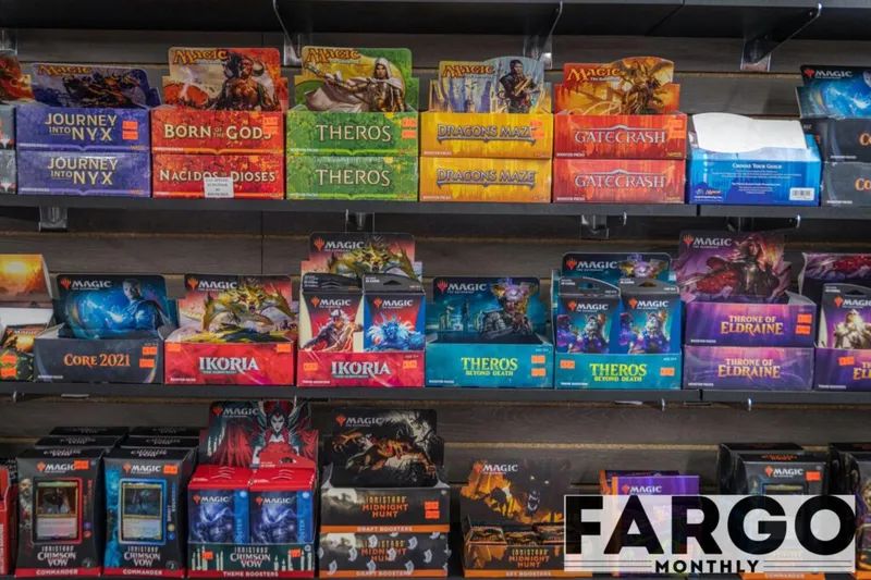 Store shelves stocked with Magic: The Gathering booster box sets including Theros, Ikoria, and Throne of Eldraine