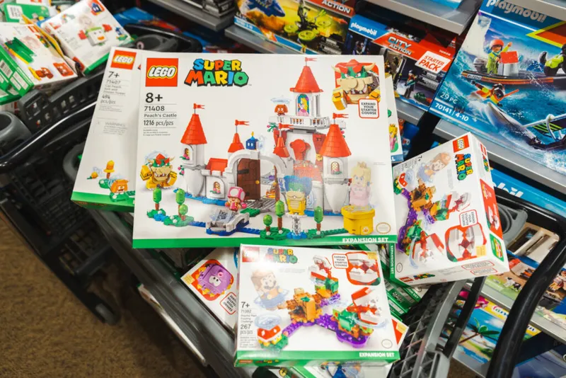 LEGO Super Mario Peach's Castle set displayed among other toy boxes in a store bin