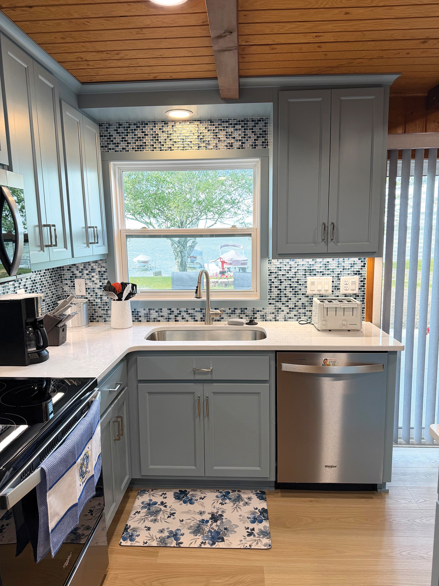 Lake cottage kitchen sink and blue cabinetry