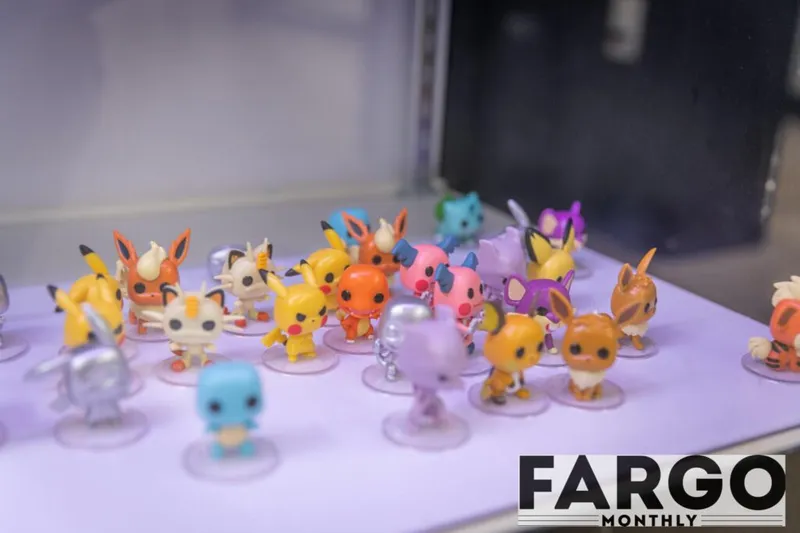 Colorful Pokémon Funko Pop mini figures displayed on a lit shelf