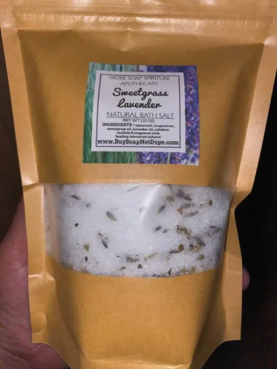 Kraft paper pouch of Sweetgrass Lavender Natural Bath Salt with a clear window showing white salt and dried herbs