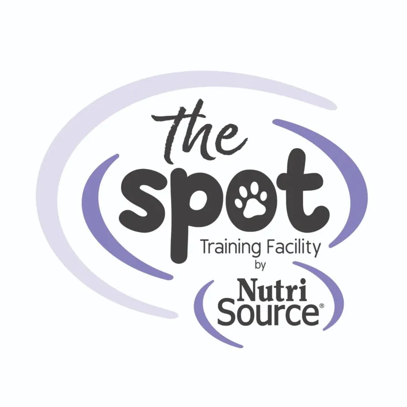 The Spot Training Facility by NutriSource logo with paw print