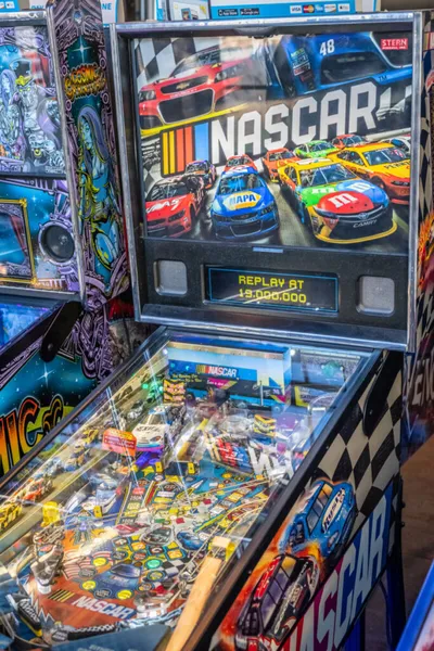 NASCAR-themed pinball machine with race car artwork on the backglass