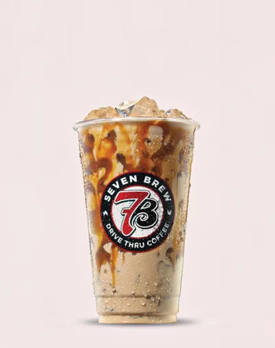 Iced coffee drink with caramel drizzle in a Seven Brew Drive Thru Coffee cup