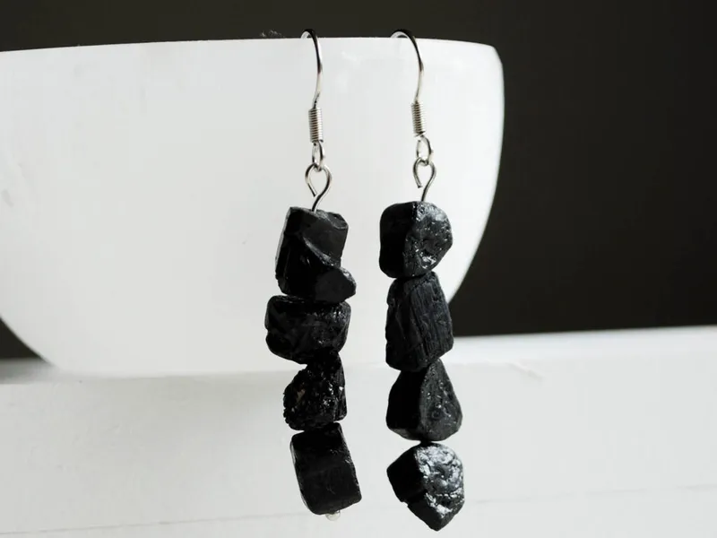 Pair of dangling earrings with stacked rough black stone beads on silver hooks