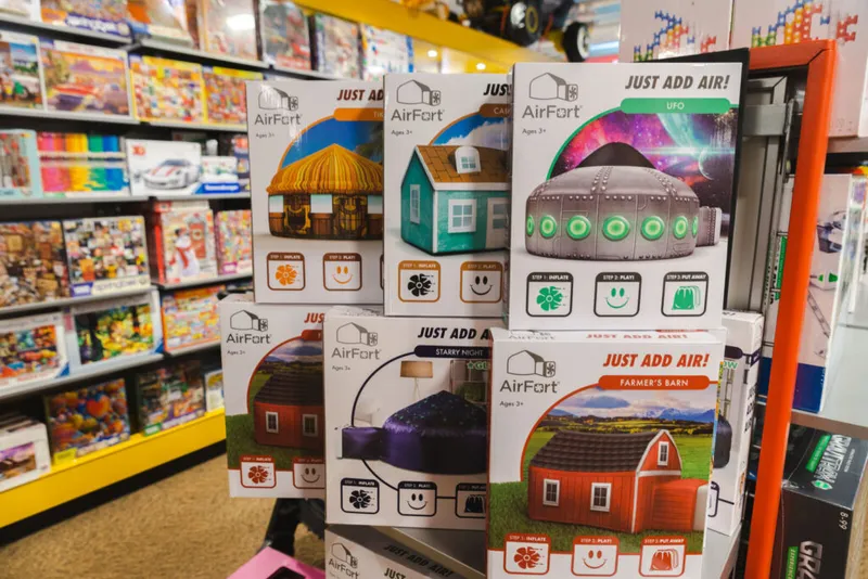Several AirFort inflatable play fort boxes displayed on a store shelf