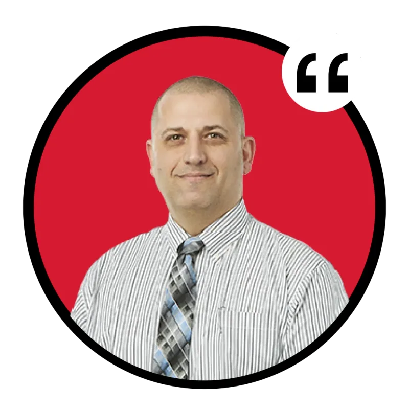 Smiling bald man in striped shirt and plaid tie on red circular background with quote marks