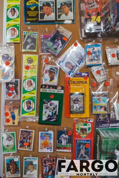 Assorted sports trading cards and team sets pinned to a corkboard display