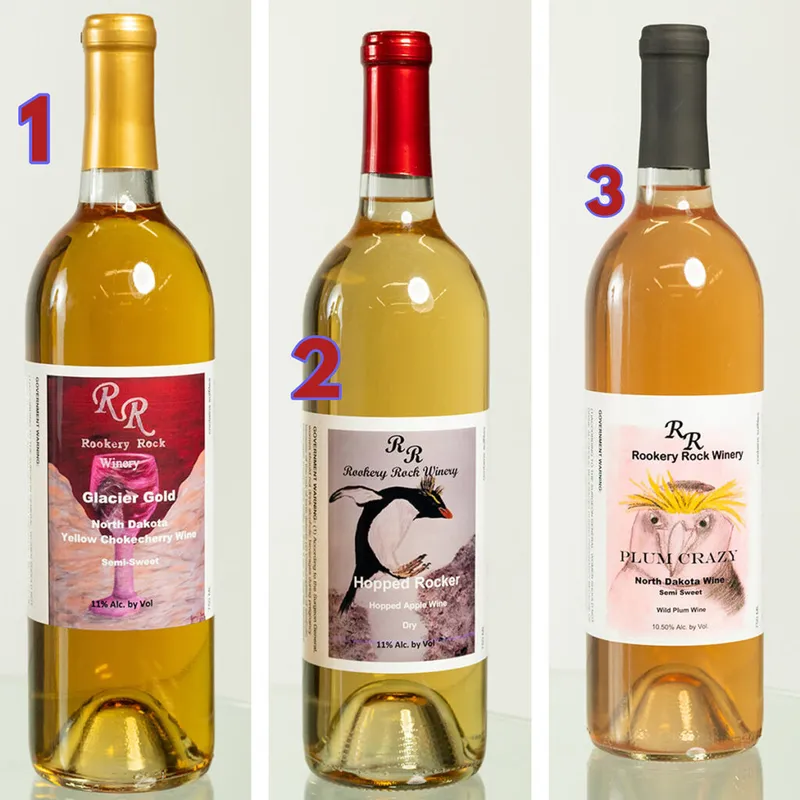 Three Rookery Rock Winery bottles: Glacier Gold, Hopped Rocker, and Plum Crazy