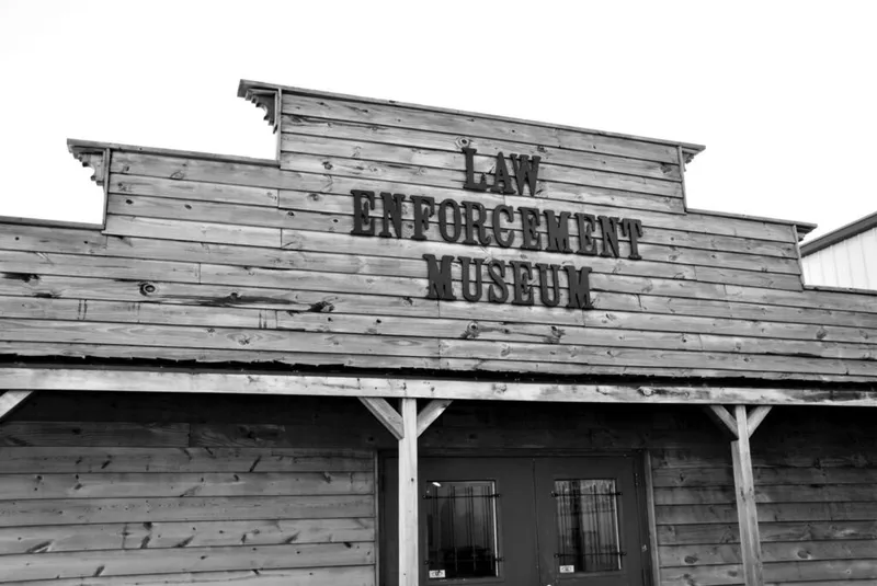 Rustic wooden Law Enforcement Museum building with Old West-style false front facade