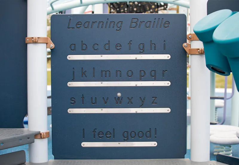 Blue playground panel titled 'Learning Braille' showing the alphabet and phrase 'I feel good!