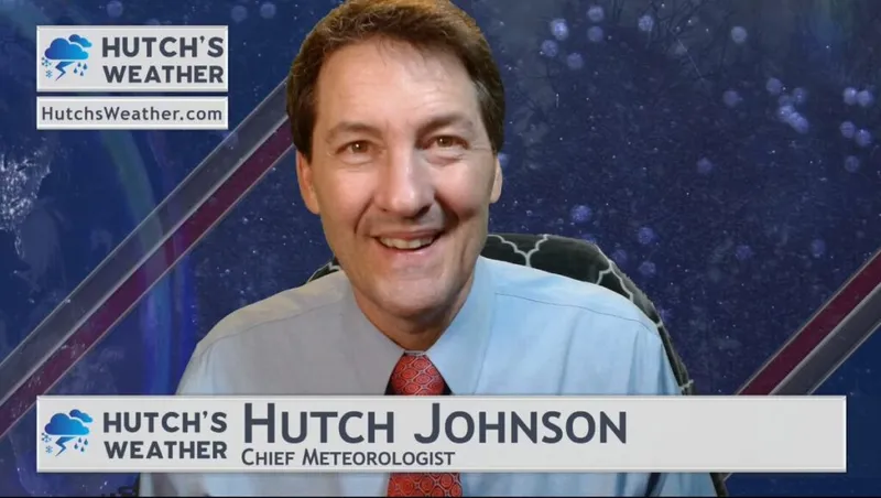 Smiling man in blue shirt and red tie identified on screen as Chief Meteorologist Hutch Johnson