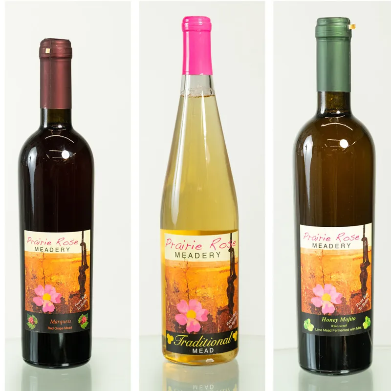 Three Prairie Rose Meadery bottles: red grape mead, traditional mead, and honey mojito mead