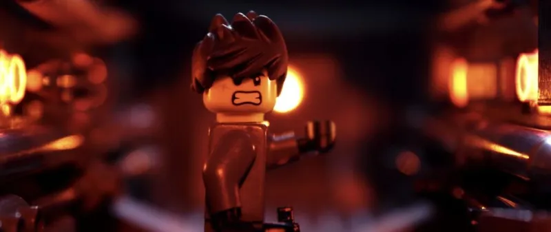 Close-up of an angry brown-haired LEGO minifigure in a dimly lit orange-glowing scene