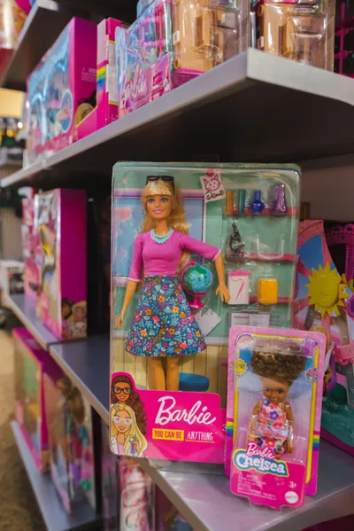 Barbie 'You Can Be Anything' doll in packaging on a toy store shelf beside a Barbie Chelsea set