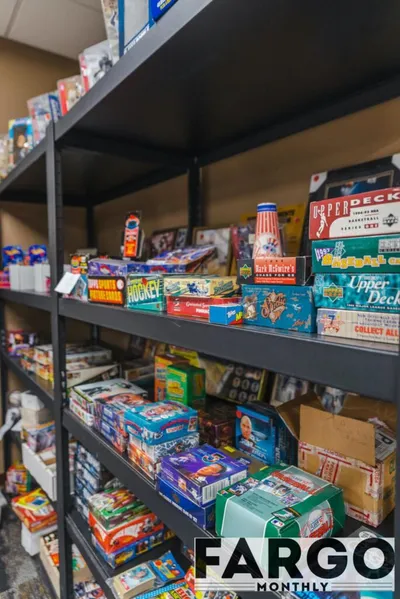 Metal shelves packed with vintage sports trading card boxes in a collectibles shop
