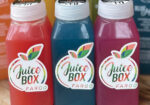 Three colorful bottled juices with Juice Box brand labels