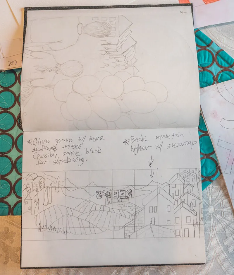 Open sketchbook with pencil drawings of buildings and hills, handwritten notes about olive grove and mountain details