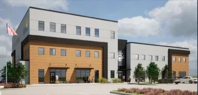 Modern two-story building with wood panel accents and an American flag out front