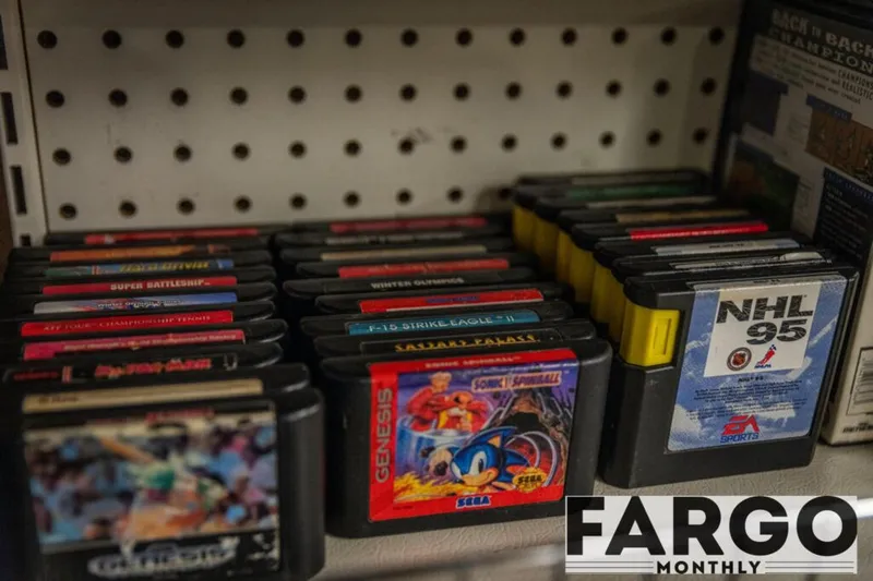 Sega Genesis cartridges on a shelf, including Sonic Spinball and NHL 95