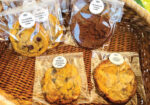 Four individually wrapped cookies in a wicker basket