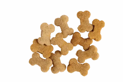 Pile of bone-shaped dog biscuits on a white background