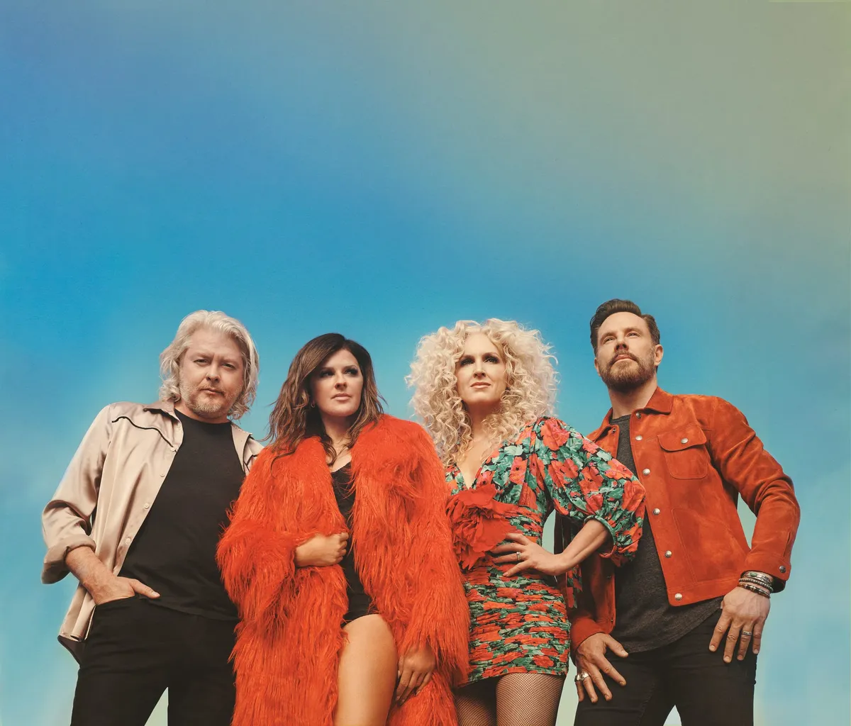 Four performers in bold red and floral outfits posed against a blue-green gradient background