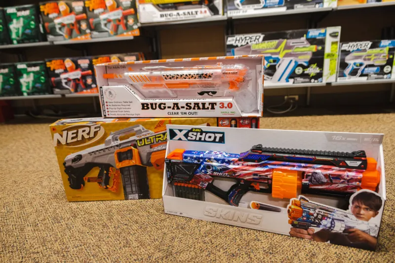 Three boxed toy blasters — Nerf Ultra, X-Shot Skins, and Bug-A-Salt 3.0 — on a store floor