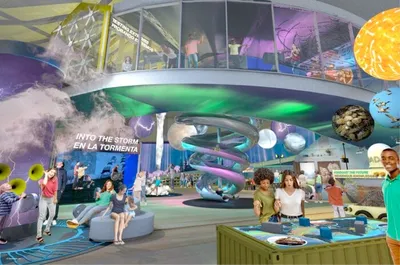 Architectural rendering of a science museum interior with spiral slide, planetary displays, and visitors exploring exhibits