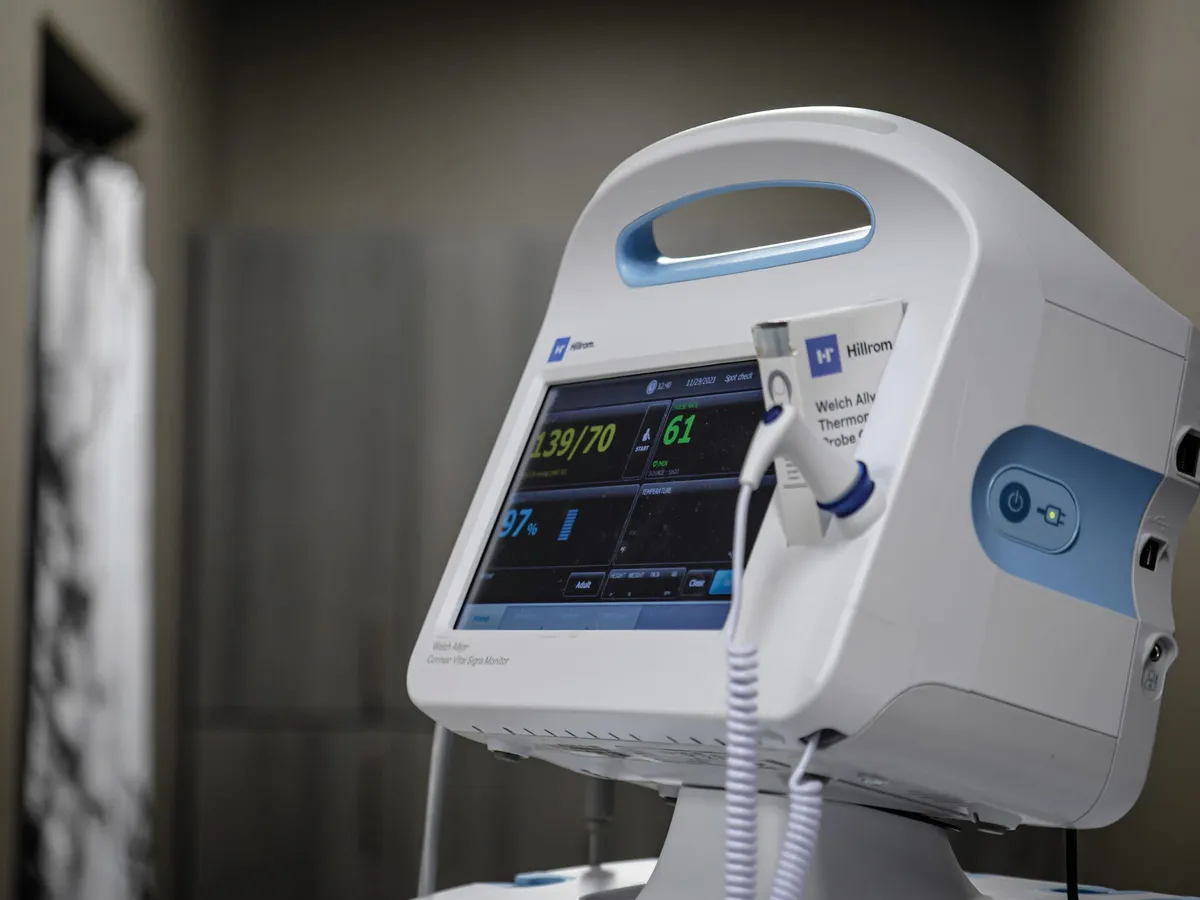 Hillrom vital signs monitor displaying blood pressure 139/70 and oxygen saturation 97%
