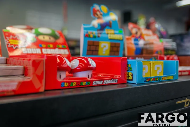 Super Mario–branded sour candies and coin candies displayed on a retail shelf