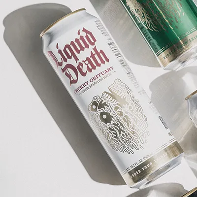 Liquid Death Cherry Obituary sparkling water tall can lying flat on a white surface