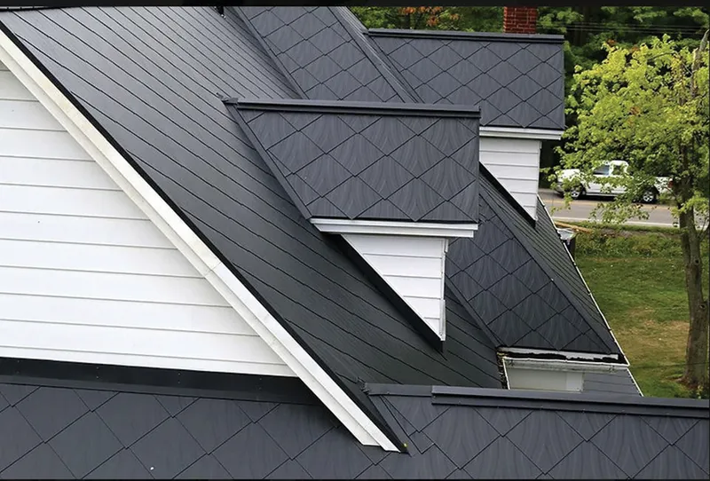 Dark gray diamond-pattern metal roof with white dormers and siding