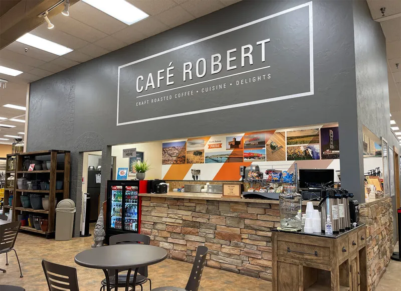 Café Robert counter with stone facade inside a retail store, seating in foreground